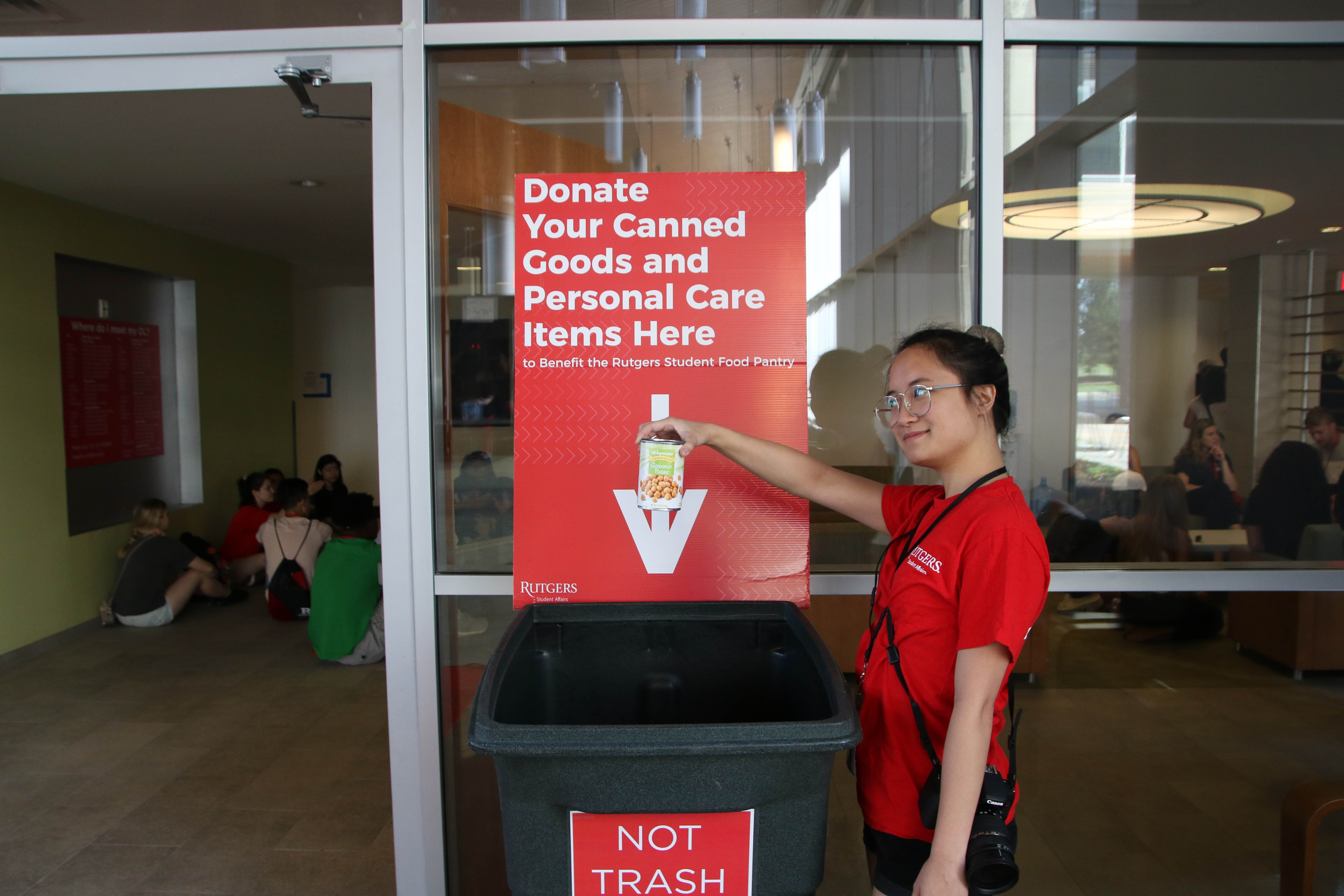 Girl posing with canned food in her hand